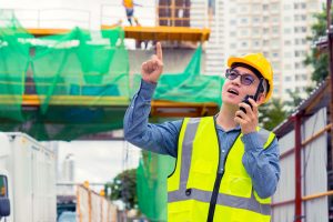 Male engineer looking at issues on construction site that may be causing delays